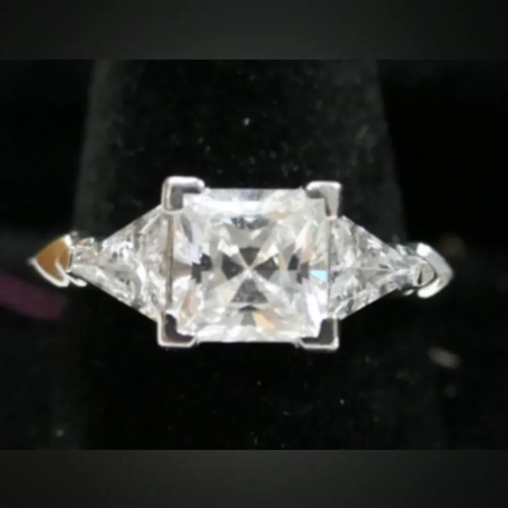 Sterling Silver Ring with Princess Cut Center CZ Stone Flanked by Triangular CZs